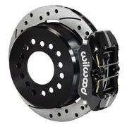Wilwood Dynapro Low-Profile brake kit: A black low-profile Dynapro caliper beside a drilled-and-slotted rotor with a deep black hat; 11-inch rear brake setup for 12-Bolt C-Clip.