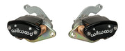 Wilwood MC4 brake kit: Two black MC4 mechanical parking-brake calipers viewed at opposing angles with silver actuating arms visible; for compatible 12.19-inch Pro Series rear brakes.