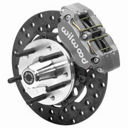 Wilwood Dynapro brake kit: Single anodized Dynapro caliper beside a drilled rotor and aluminum wheel hub with protruding wheel studs; 10.75-inch front brake setup for Pinto/Mustang II/Bobcat.