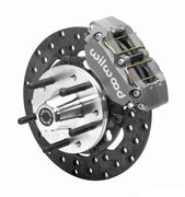 Wilwood Dynapro brake kit: An anodized Dynapro caliper beside a thin drilled rotor and aluminum hub with five protruding wheel studs; 10.75-inch front brake setup for Mustang/Thunderbird.