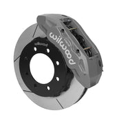 Wilwood TX6R brake kit: A gray anodized TX6R caliper above a slotted rotor and black eight-hole hat in an angled assembly; 15-inch front brake setup for F-250/F-350 4WD SRW.