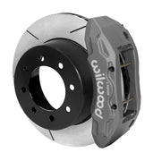Wilwood TX6R brake kit: A gray anodized TX6R caliper beside a slotted rotor with a deep black integral eight-hole hat; 15.5-inch rear brake setup for Super Duty 4WD SRW.