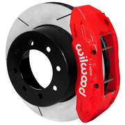 Wilwood TX6R brake kit: A red TX6R caliper beside a slotted rotor with a deep black integral eight-hole hat; 15.5-inch rear brake setup for Super Duty 4WD SRW.