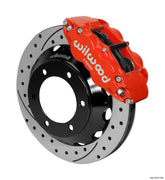 Wilwood Superlite 6R brake kit: A red Superlite caliper above a drilled-and-slotted rotor and deep black six-hole hat; 12.88-inch front brake setup for Toyota/Lexus Six-Lug.