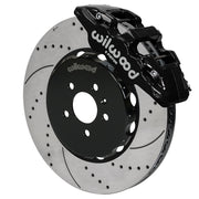 Wilwood AERO6 brake kit: Angled assembly of a black AERO6 caliper beside a drilled-and-slotted rotor and black five-hole hat; 15-inch front brake setup for Audi A4/A5/S4/S5.