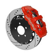 Wilwood AERO6 brake kit: A red caliper alongside a drilled-and-slotted rotor attached to a dark five-hole hat in an angled view; 14-inch front brake setup for Ford Panther Cars.