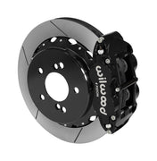 Wilwood Superlite 4R brake kit: A black caliper beside a slotted rotor mounted to a black five-hole hat, viewed at an angle; 12.88-inch rear brake setup for BMW E46 M3.