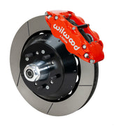 Wilwood Superlite 6R brake kit: A red caliper beside a slotted rotor and deep black hat over a wheel hub, with visible studs and a polished dust cap; 14-inch front brake setup for 1957–1967 F-100.