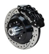 Wilwood Superlite 6R brake kit: A black caliper beside a drilled-and-slotted rotor and deep black hat over a wheel hub, with visible studs and a polished dust cap; 12.88-inch front brake setup for 1968–1972 F-100 2WD.