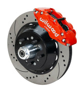 Wilwood F-100 4x2 drum-spindle front assembly with a red Superlite 6R caliper, 14.00-inch drilled-and-slotted rotor and central wheel hub with studs