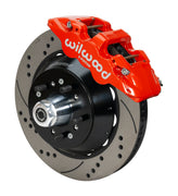 Wilwood F-100 AERO6 drum-spindle front assembly with a red AERO6 caliper, 14.00-inch drilled-and-slotted rotor and central wheel hub with studs