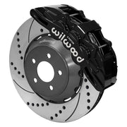 Wilwood Mustang or Ridetech hub-spindle 15-inch front assembly with a black SX6R caliper beside a 15.00-inch drilled-and-slotted rotor and its mounting hat