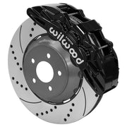 Wilwood Mustang or Ridetech hub-spindle 14-inch front assembly with a black SX6R caliper beside a 14.00-inch drilled-and-slotted rotor and its mounting hat
