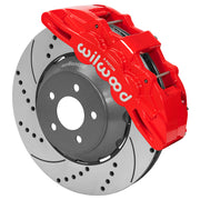 Wilwood Mustang or Ridetech hub-spindle 14-inch front assembly with a red SX6R caliper beside a 14.00-inch drilled-and-slotted rotor and its mounting hat