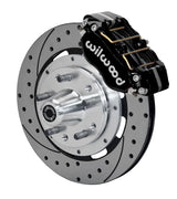 Wilwood black four-piston front caliper beside a 12.19-inch drilled-and-slotted rotor with projecting wheel hub for the 1970–1974 Ford/Mercury spindle installation
