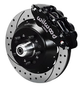 Wilwood black six-piston front caliper beside a 14-inch drilled-and-slotted rotor, separate hat and projecting hub for the ProSpindle front installation