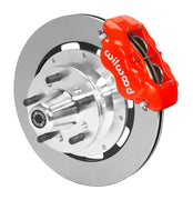 Wilwood red four-piston front caliper beside a 12.19-inch plain-face rotor with projecting wheel hub for the early A-body 12.19-inch front installation
