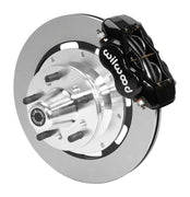 Wilwood black four-piston front caliper beside a 12.19-inch plain-face rotor with projecting wheel hub for the early A-body 12.19-inch front installation