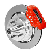 Wilwood red four-piston front caliper beside a 12.19-inch plain-face rotor with projecting wheel hub for the later Mopar 12.19-inch front installation