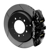 Wilwood black AERO4-DS caliper beside a 14.5-inch slotted rotor with its integral parking hat for the Toyota/Lexus 14.50-inch rear arrangement