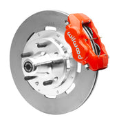 Wilwood red four-piston front caliper beside a 12.19-inch plain-face rotor with projecting wheel hub for the CPP Tri-Five 12.19-inch front installation