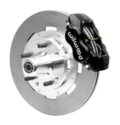 Wilwood black four-piston front caliper beside a 12.19-inch plain-face rotor with projecting wheel hub for the CPP Tri-Five 12.19-inch front installation
