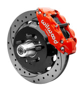 Wilwood red six-piston front caliper beside a 12.88-inch drilled-and-slotted rotor, separate hat and projecting hub for the CPP Tri-Five 12.88-inch front installation