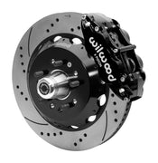 Wilwood black six-piston front caliper beside a 14-inch drilled-and-slotted rotor, separate hat and projecting hub for the CPP Tri-Five 14-inch Superlite front installation
