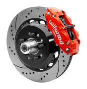Wilwood red six-piston front caliper beside a 14-inch drilled-and-slotted rotor, separate hat and projecting hub for the CPP Tri-Five 14-inch Superlite front installation