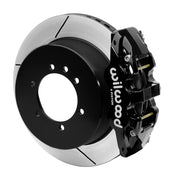 Wilwood black AERO4-DS caliper beside a 14.25-inch slotted rotor with its integral parking hat for the Patrol Y61 rear arrangement
