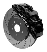 Wilwood SX6R front brake kit, Corvette C7, 15-inch SRP rotors: Assembled brake view with black SX6R caliper over a drilled & slotted rotor and black central hat; no projecting replacement wheel hub is shown.