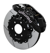 Wilwood TX6R front brake kit, F-150 SVT Raptor 2010–2014, 15.5-inch GT rotors: Assembled brake view with black TX6R caliper over a gt slotted rotor and black central hat; no projecting replacement wheel hub is shown.