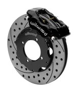 Wilwood Dynalite front brake kit, TR4A / TR250 / TR6, 11-inch SRP rotors: Assembled brake view with black Dynalite caliper over a drilled & slotted rotor and black central hat; no projecting replacement wheel hub is shown.