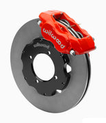 Wilwood Dynalite front brake kit, TR4A / TR250 / TR6, 11-inch plain rotors: Assembled brake view with red Dynalite caliper over a plain face rotor and black central hat; no projecting replacement wheel hub is shown.