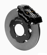 Wilwood Dynalite front brake kit, TR4A / TR250 / TR6, 11-inch plain rotors: Assembled brake view with black Dynalite caliper over a plain face rotor and black central hat; no projecting replacement wheel hub is shown.