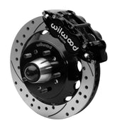 Wilwood Superlite 6R front brake kit, five-lug GM truck/SUV iron ProSpindles, 13.06-inch SRP rotors: Assembled brake view with black Superlite 6R caliper, drilled & slotted rotor, black hat/adapter and projecting hub with wheel studs.
