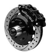 Wilwood Superlite 6R front brake kit, six-lug GM truck/SUV iron ProSpindles, 13.06-inch SRP rotors: Assembled brake view with black Superlite 6R caliper, drilled & slotted rotor, black hat/adapter and projecting hub with wheel studs.