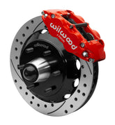 Wilwood Superlite 6R front brake kit, six-lug GM truck/SUV iron ProSpindles, 13.06-inch SRP rotors: Assembled brake view with red Superlite 6R caliper, drilled & slotted rotor, black hat/adapter and projecting hub with wheel studs.