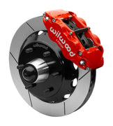 Wilwood Superlite 6R front brake kit, six-lug GM truck/SUV iron ProSpindles, 13.06-inch GT rotors: Assembled brake view with red Superlite 6R caliper, gt slotted rotor, black hat/adapter and projecting hub with wheel studs.
