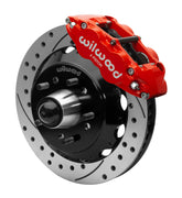 Wilwood Superlite 6R front brake kit, later GM truck/van/SUV iron ProSpindles, 13.06-inch SRP rotors: Assembled brake view with red Superlite 6R caliper, drilled & slotted rotor, black hat/adapter and projecting hub with wheel studs.