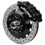 Wilwood Superlite 6R front brake kit, GM second-generation AFX ProSpindles, 12.88-inch SRP rotors: Assembled brake view with black Superlite 6R caliper, drilled & slotted rotor, black hat/adapter and projecting hub with wheel studs.