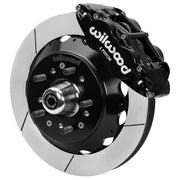 Wilwood Superlite 6R front brake kit, GM second-generation AFX ProSpindles, 12.88-inch GT rotors: Assembled brake view with black Superlite 6R caliper, gt slotted rotor, black hat/adapter and projecting hub with wheel studs.