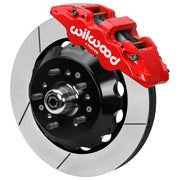 Wilwood red front caliper beside the assembled 14.00-inch slotted rotor for the GM second-generation AFX ProSpindle brake conversion, with the hub and wheel studs visible