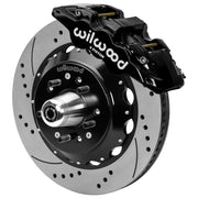 Wilwood black front caliper beside the assembled 14.00-inch drilled and slotted rotor for the GM G-Body and related disc-spindle brake conversion, with the hub and wheel studs visible