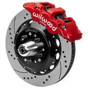 Wilwood red front caliper beside the assembled 14.00-inch drilled and slotted rotor for the GM G-Body and related disc-spindle brake conversion, with the hub and wheel studs visible