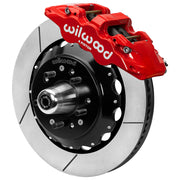 Wilwood red front caliper beside the assembled 14.00-inch slotted rotor for the GM G-Body and related disc-spindle brake conversion, with the hub and wheel studs visible