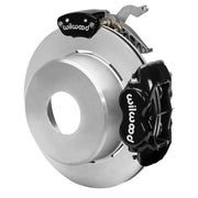 Wilwood black rear caliper beside the assembled 12.19-inch undrilled rotor for the Currie Pro-Tour blank-pattern floater brake conversion, with a separate MC4 parking caliper