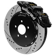 Wilwood black front caliper beside the assembled 14.00-inch drilled and slotted rotor for the 1994–2004 Ford Mustang brake conversion