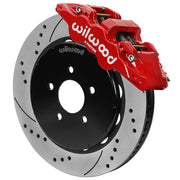 Wilwood red front caliper beside the assembled 14.00-inch drilled and slotted rotor for the 1994–2004 Ford Mustang brake conversion