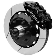 Wilwood black front caliper beside the assembled 14.00-inch slotted rotor for the Chevrolet/GMC six-lug 14-inch Superlite drop-spindle brake conversion, with the hub and wheel studs visible